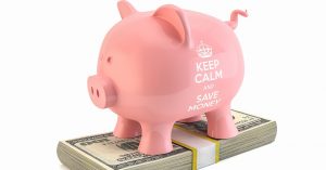 Piggy bank that says keep calm and save money - sitting on a stack of 100 dollar bills | Gunther Kia