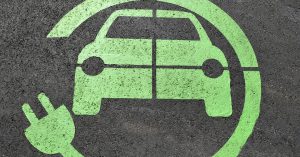 Lime green hybrid parking logo on cement | Gunther Kia