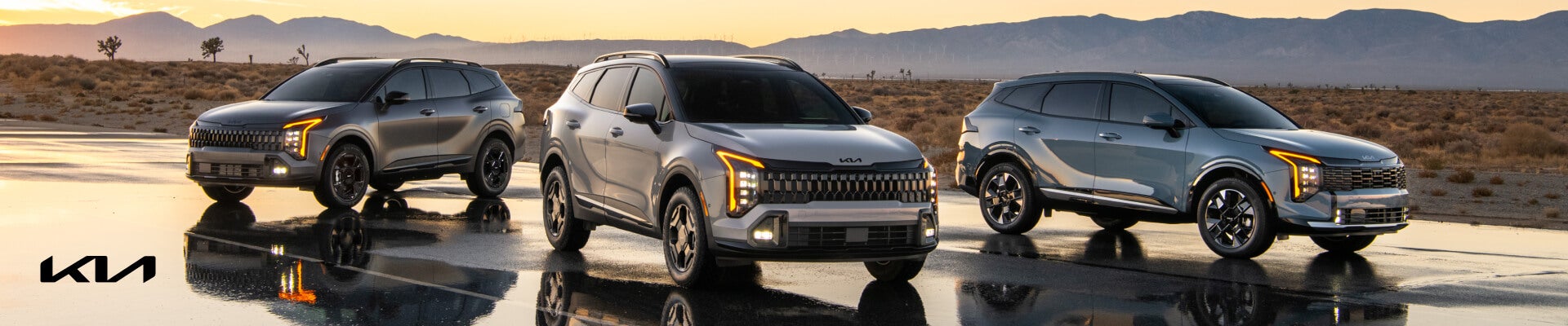 2026 Kia Sportage lineup at sunset: X-Pro Prestige Panthera Metal, X-Line PHEV Wolf Gray, and SX Prestige HEV Heritage Blue.