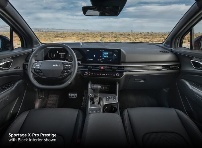 2026 Kia Sportage X-Pro Prestige with Black interior, front cabin view showing dashboard, screens and center console.