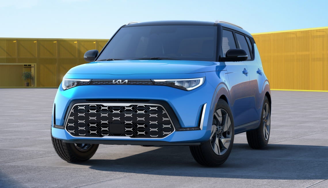 Blue Kia Soul shown from a front three-quarter angle in a modern outdoor setting.
